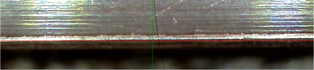 Close-up of a skate blade edge with measurement reference lines.